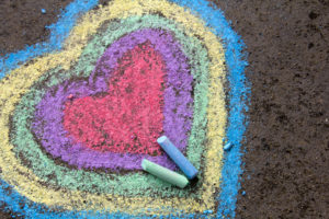 chalk drawing: colorful hearts on asphalt