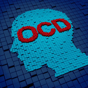 A head with the acronym for obsessive compulsive disorder written on it.