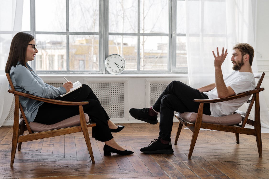 A man talking to a woman therapist.