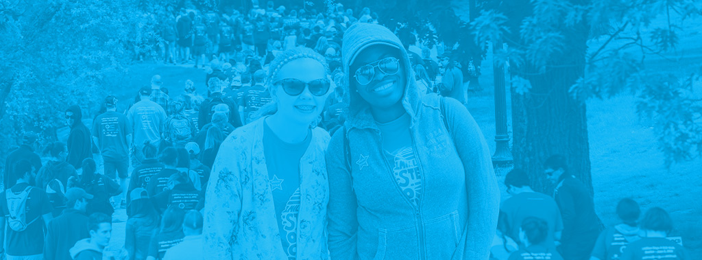 Image of a black woman and a white woman smiling, wearing and IOCDF OCD Walk shirt.